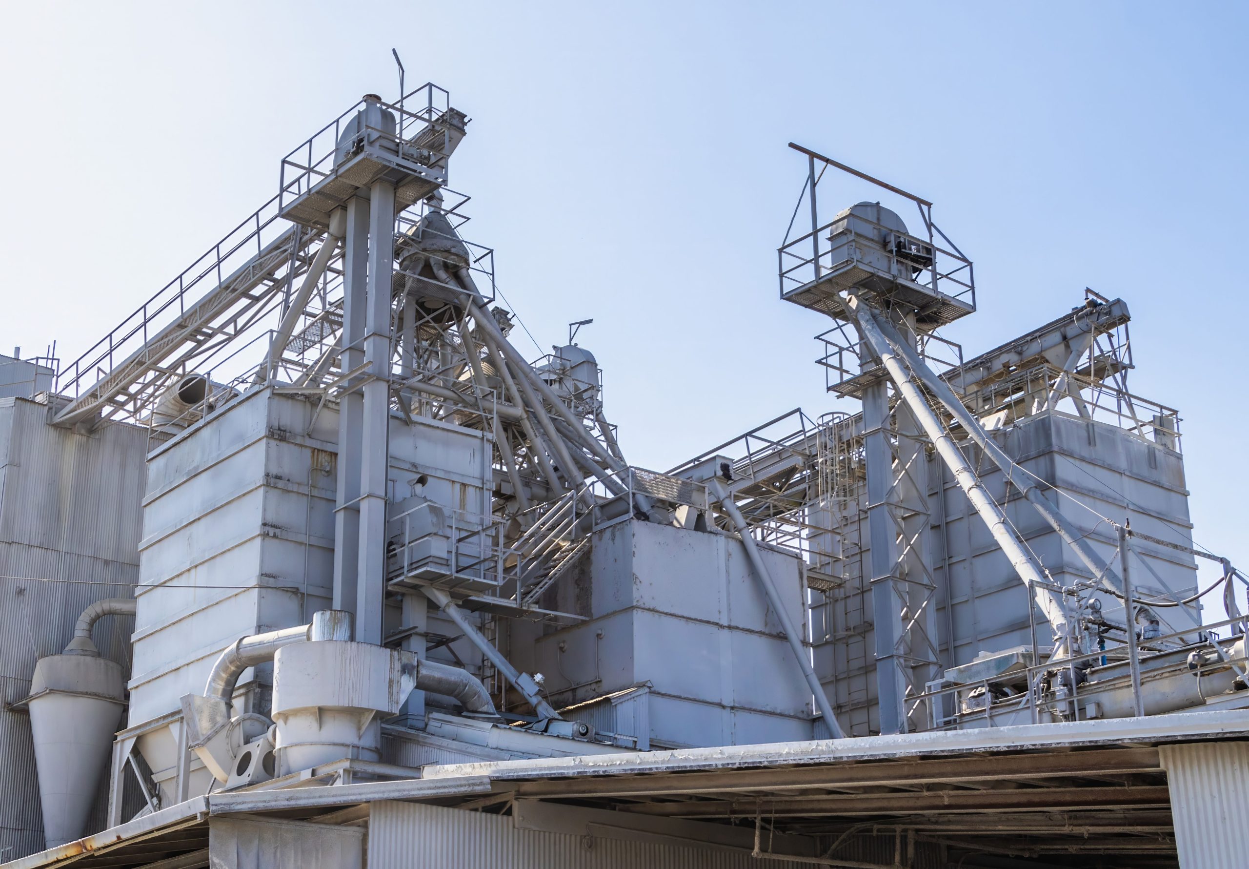 A complex industrial architecture of a cement factory showing metal structures and technology.
